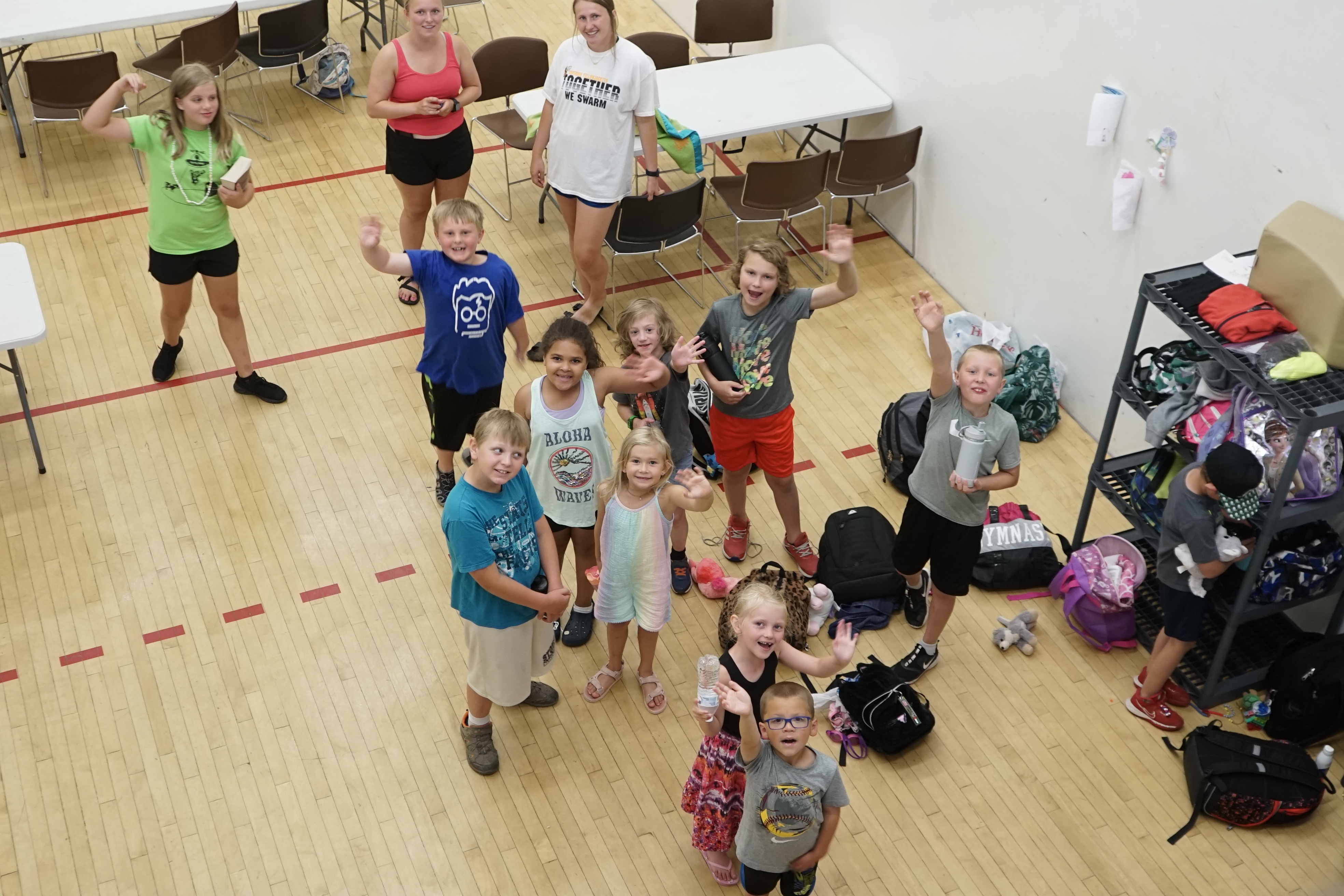 Youngsters wave from the gym inside the Superior YMCA